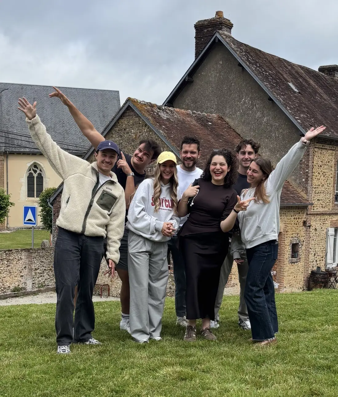 The Archipel team together, arms raised